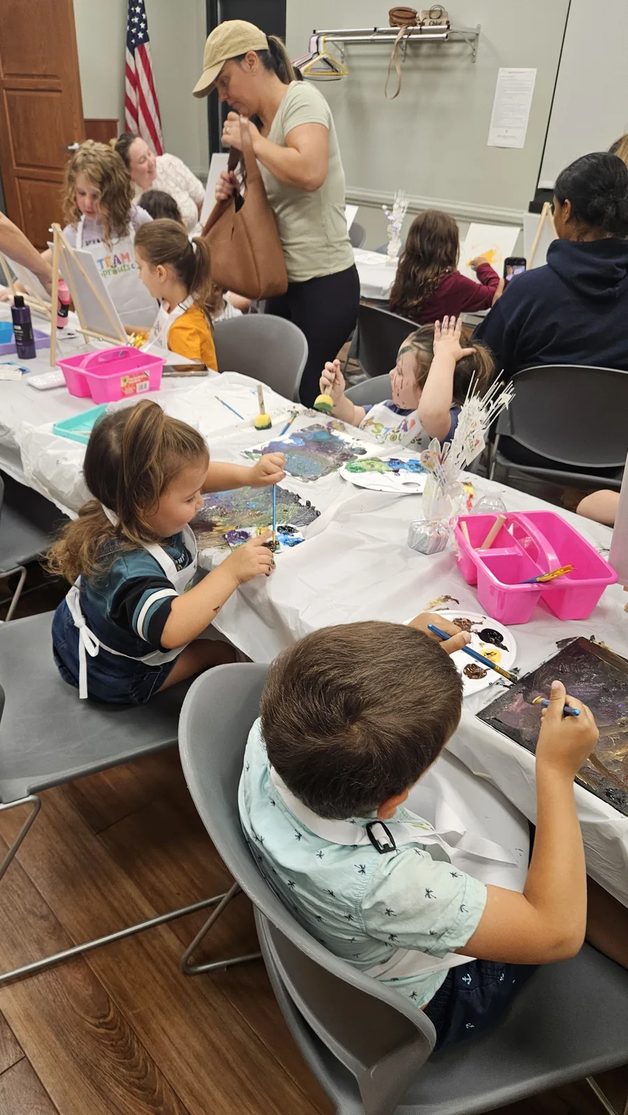 Children and adults making crafts together at a STEAM Sprouts workshop