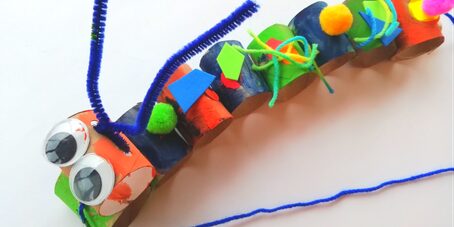Close-up of a finished wiggly caterpillar craft made from cardboard tubes